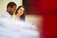 Smiling man and woman in an office