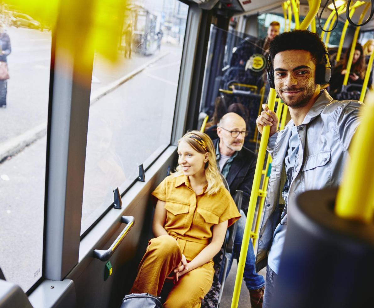 Smiling people looking outside from the bus. Smiling people looking outside from the bus.
