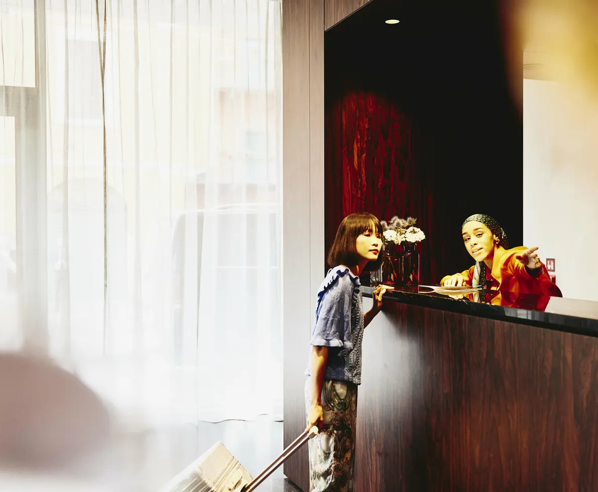 Hotel receptions giving directions to a hotel guest.
